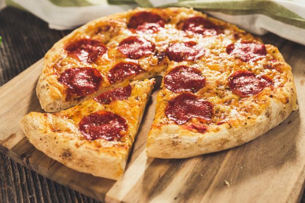 Pepperoni pizza on rustic background