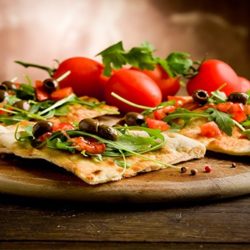 Thin pizza with tomato and vegetables